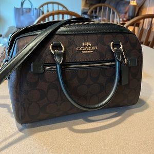 Brand: Coach. Size: 10” (L), 6 1/2” (H). Color: Gold/Brown Black